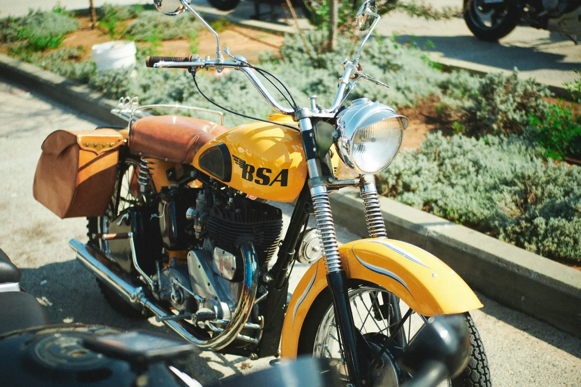 a yellow motorcycle parked on the side of the road