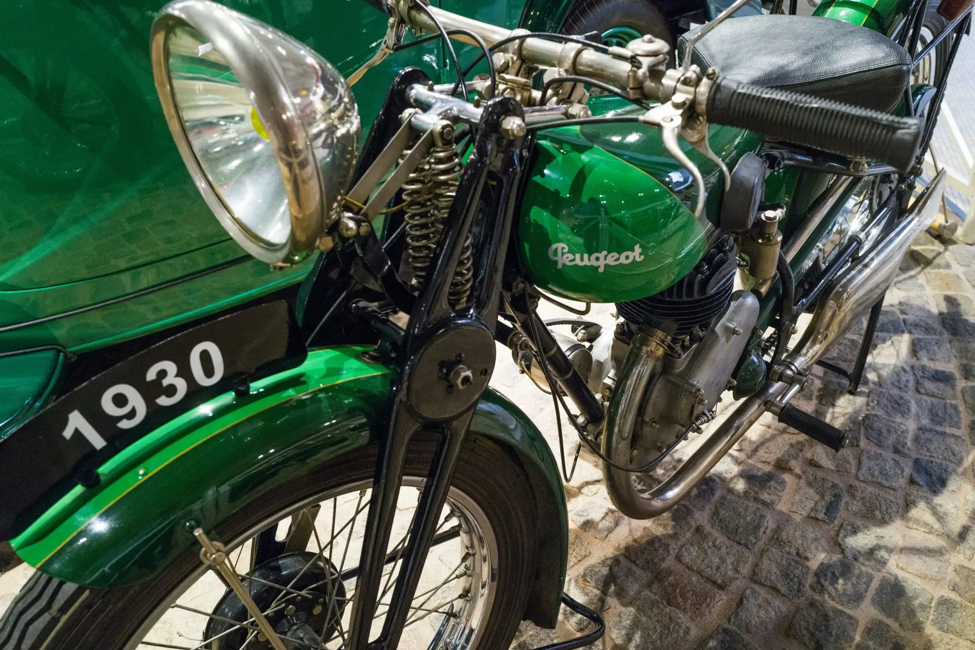 a green motorcycle parked on a stone surface